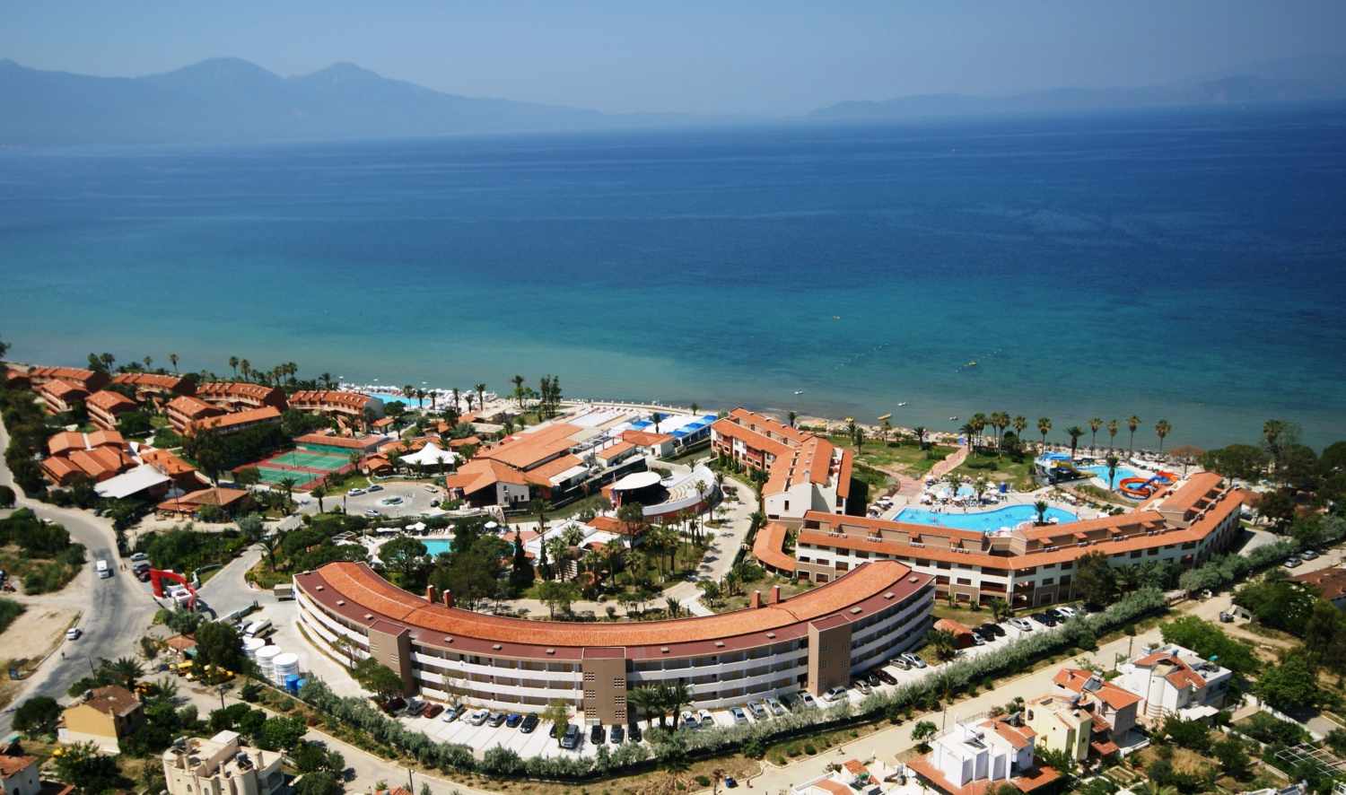 LiggingEphesia Holiday Beach Club ligt aan de Egeïsche kust en biedt een privé zandstrand & ligt op zo'n 7 KM van het centrum van Kuşadası HotelfaciliteitenHet hotel beschikt over 5 zwembaden en 2 grote waterglijbanen voor veel waterpret. Het hotel biedt tevens een kermis voor kinderen van 0 tot 12 jaar en een miniclub voor kinderen van 4 tot 12 jaar. Er zelfs een verwarmd kinderzwembad aanwezig. Het spa- en wellnesscentrum van Ephesia Holiday Beach Club biedt ontspanning met onder andere een Turks bad en sauna. Voor de actieve gasten is er een fitnesscentrum en een tennisbaan beschikbaar. KamersDe kamers zijn smaakvol ingericht en bieden een comfortabele en gezellige ambiance. Alle kamers zijn voorzien van airconditioning en beschikken over een eigen badkamer en balkon of terras.  Eten en drinkenDe eetgelegenheden in Ephesia Holiday Beach Club zijn divers en bieden voor ieder wat wils: